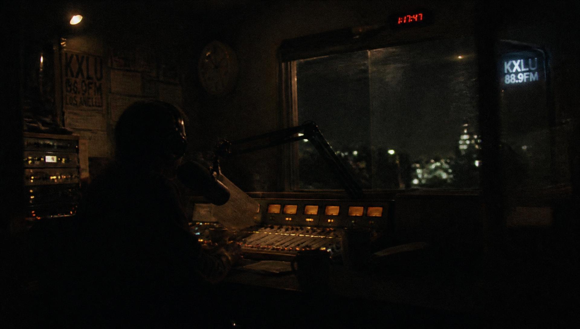 Broadcast studio at night with a dim mixing console